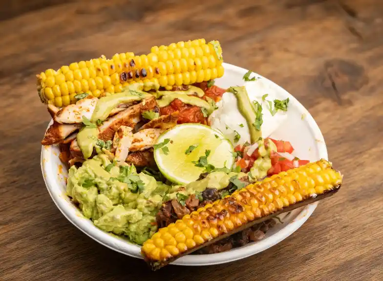 Freak Eats bowl with corn ribs, guacamole and lime