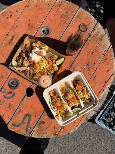 Nachos and tacos served at an event table - Freak Eats food truck gallery