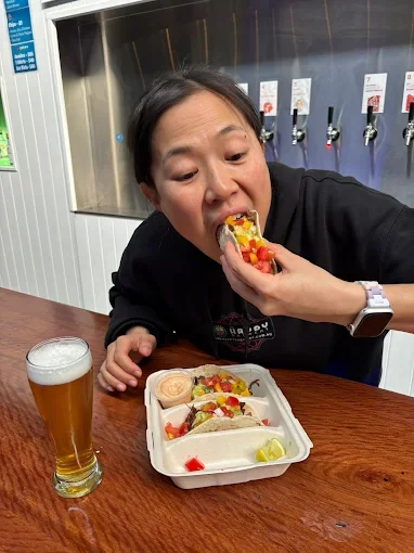 Guest enjoying Freak Eats tacos at Happy Brewery - Freak Eats