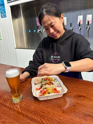 Guest digging into tacos at Happy Brewery - Freak Eats food truck gallery